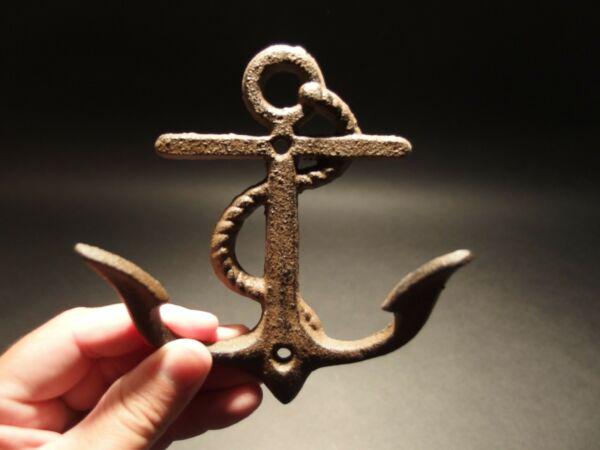 Cast Iron Fouled Navy Anchor Hook Coat Hanger Hardware: 5 1/4"Tall x 4 3/4" Wide x 1 1/2" Extension Such a neat reproduction cast iron fouled Navy anchor wall hook. As you can see this all cast iron anchor hook has barbs leaning forward enough to hang some