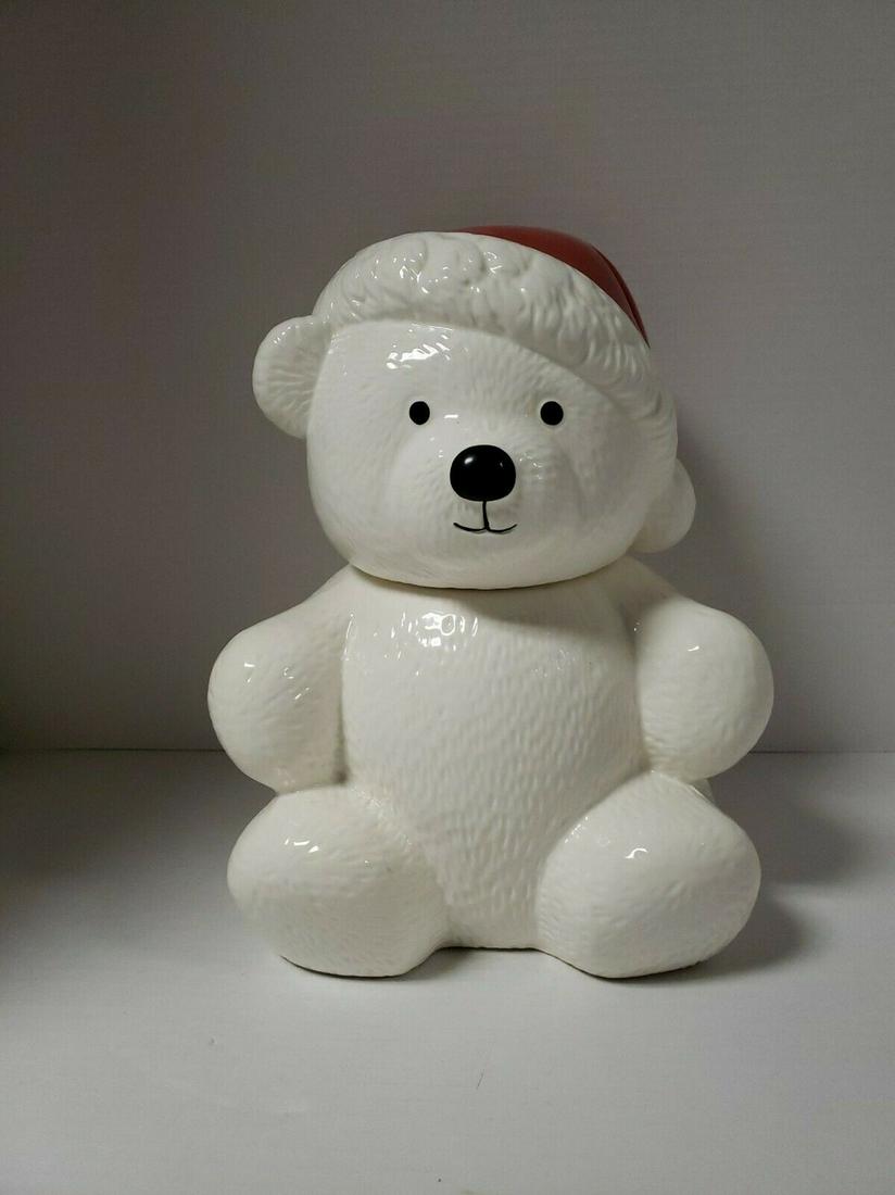 Figure polar bear with red hat cookie jar pot stoneware: Title: Figure polar bear with red hat cookie jar pot stoneware Date/Period: 20 century Materials: Stoneware Dimensions: Width: 8 inchHeight:11 inchLength: 8 inch Description:White Polar Bear with Red