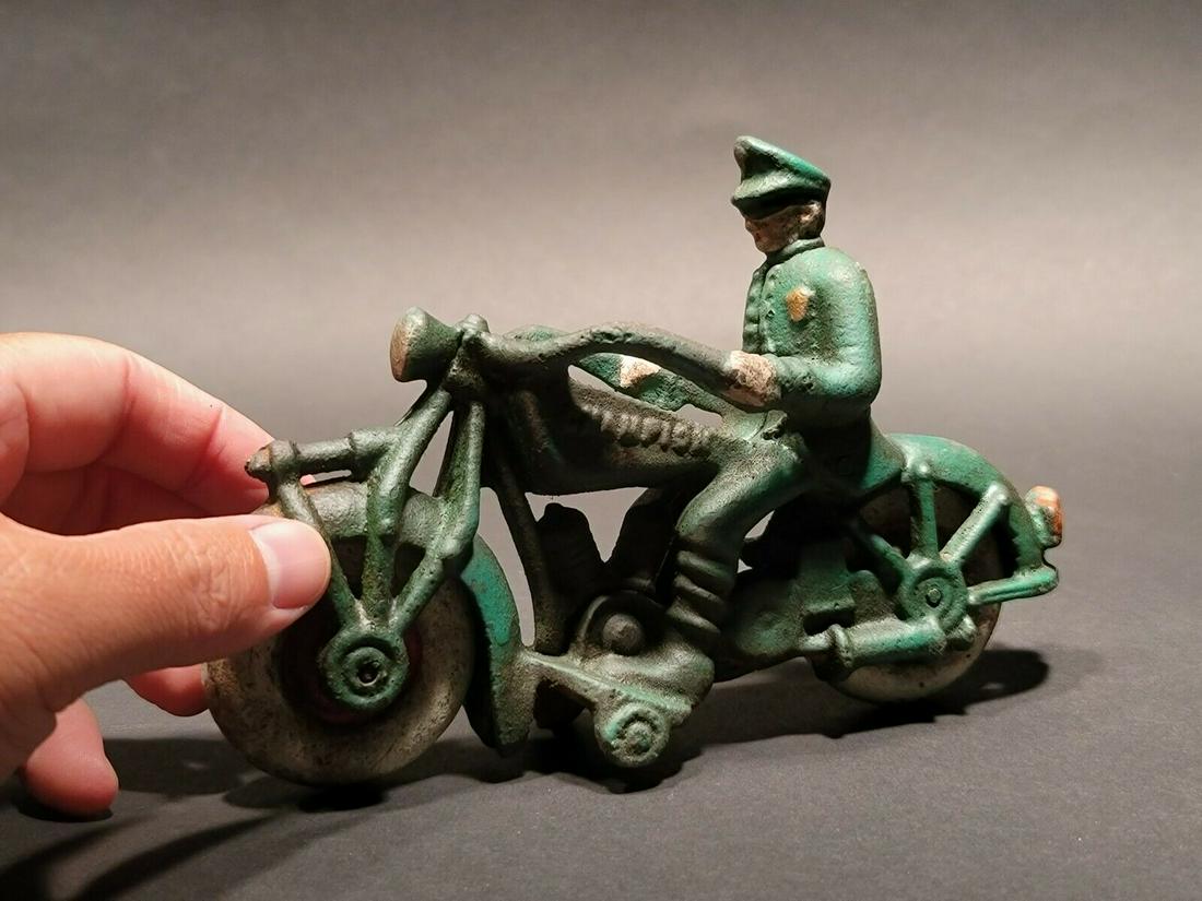 Cast Iron Toy Motorcycle Police Patrol Rider: 7" Long x 4 1/2" Tall Such a neat reproduction cast iron motorcycle! As you can see this heavy cast iron pull toy motorcycle was wonderfully hand painted and distressed to look like an original antiqu