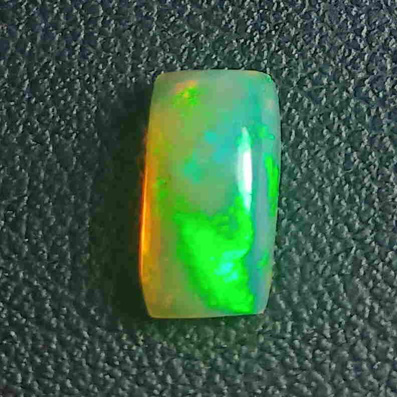 1.45 CTS NATURAL ETHIOPIAN WELO OPAL CUSHION GOOD: Title: 1.45 CTS NATURAL ETHIOPIAN WELO OPAL CUSHION GOOD LUSTER LOOSE GEMSTONES Carat Weights: 1.45 Size/Dimensions: 10.0 x 5.5 x 3.8 MM Additional Information: UNHEATED ETHIOPIAN Reserve: $25.00 Ship
