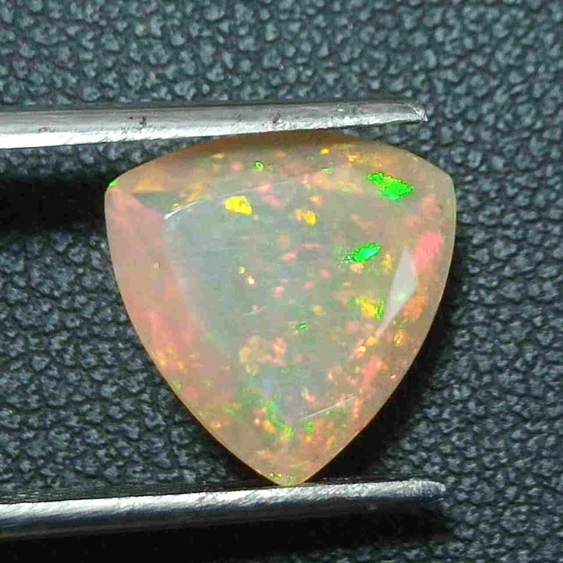 3.40 CTS GOOD LUSTER NATURAL ETHIOPIAN WELO OPAL: Title: 3.40 CTS GOOD LUSTER NATURAL ETHIOPIAN WELO OPAL TRILLION CUT LOOSE GEMSTONES Carat Weights: 3.4 Size/Dimensions: 11.7 x 11.5 x 6.8 MM Additional Information: UNHEATED ETHIOPIAN Reserve: $35.00