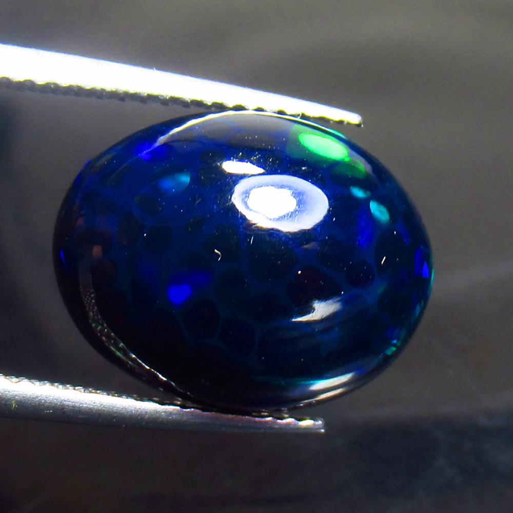 4.78 Ctw Natural Ethiopian Black Fire Opal Oval Cab: Title: 4.78 Ctw Natural Ethiopian Black Fire Opal Oval Cab Stone Clarity: Translucent Gemstone: Black Opal Carat Weights: 4.78 Size/ Dimensions: 14.70 x 11.70 x 5.90 mm Additional Info: Excellent Oval