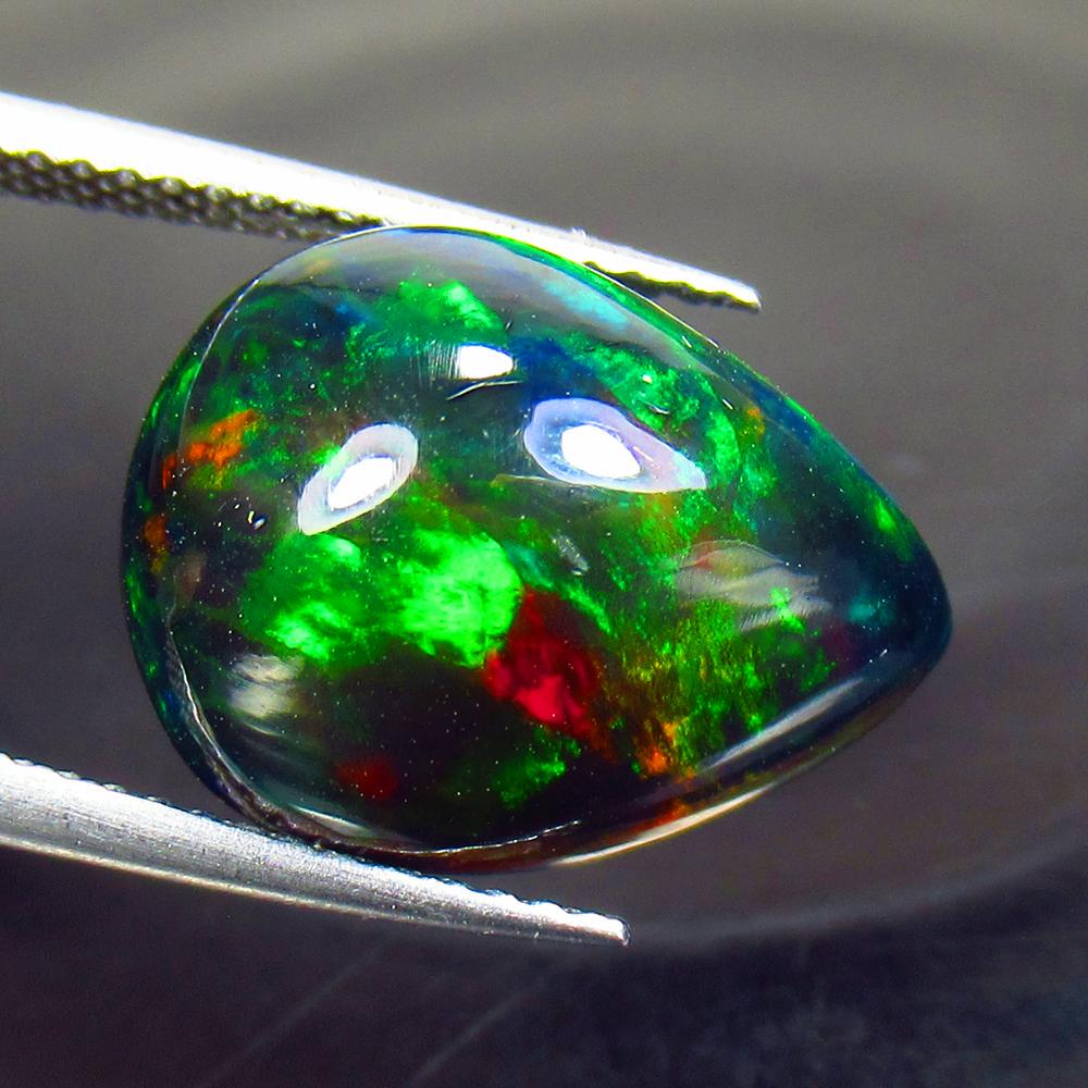 6.53 Ctw Natural Ethiopian Black Fire Opal Pear Cab: Title: 6.53 Ctw Natural Ethiopian Black Fire Opal Pear Cab Stone Clarity: Translucent Gemstones: Black Opal Carat Weights: 6.53 Size/Dimensions: 16.00 x 12.00 x 7.40 mm Additional Information: Excelle