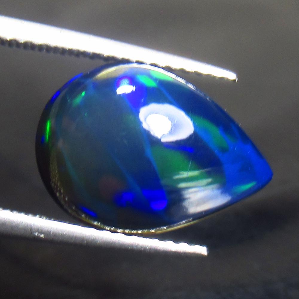 3.34 Ctw Natural Ethiopian Black Fire Opal Pear Cab: Title: 3.34 Ctw Natural Ethiopian Black Fire Opal Pear Cab Stone Clarity: Translucent Gemstone: Black Opal Carat Weights: 3.34 Size/ Dimensions: 14.20 x 10.00 x 5.50 mm Additional Info: Excellent Pear
