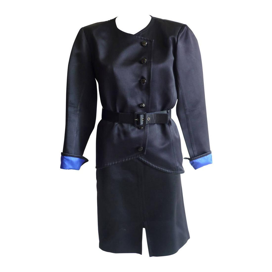 Remarkable Yves Saint Laurent RG Black Peau De Soie: Great example of an Yves Saint Laurent RG 1980s piece: big shoulders; Russian style side closure and bonded royal blue lining. The jacket is belted and the skirt is straight with a slit in the middle 