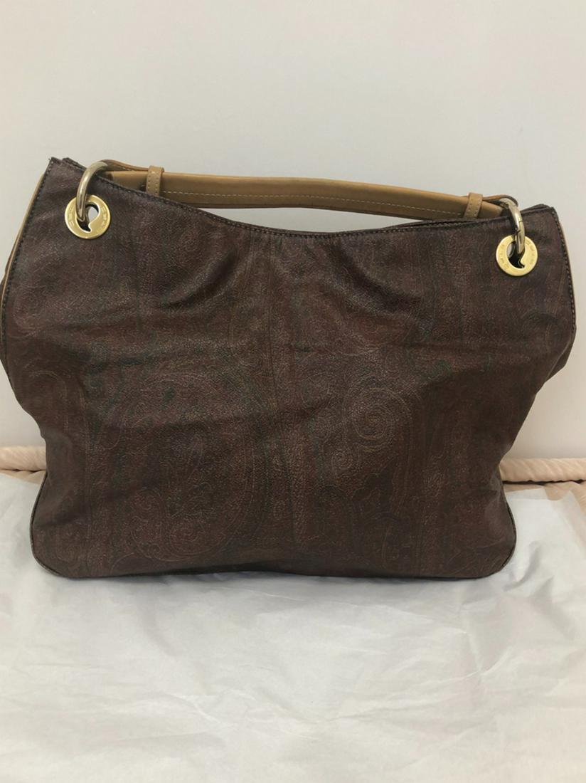 Etro Paisley Pattern Handbag: Lovely Etro coated canvas and leather bag in the iconic Etro paisley pattern, and beautifully crafted. The bag is very roomy with a red lining and a zipped pocket. All accents are gold tone including