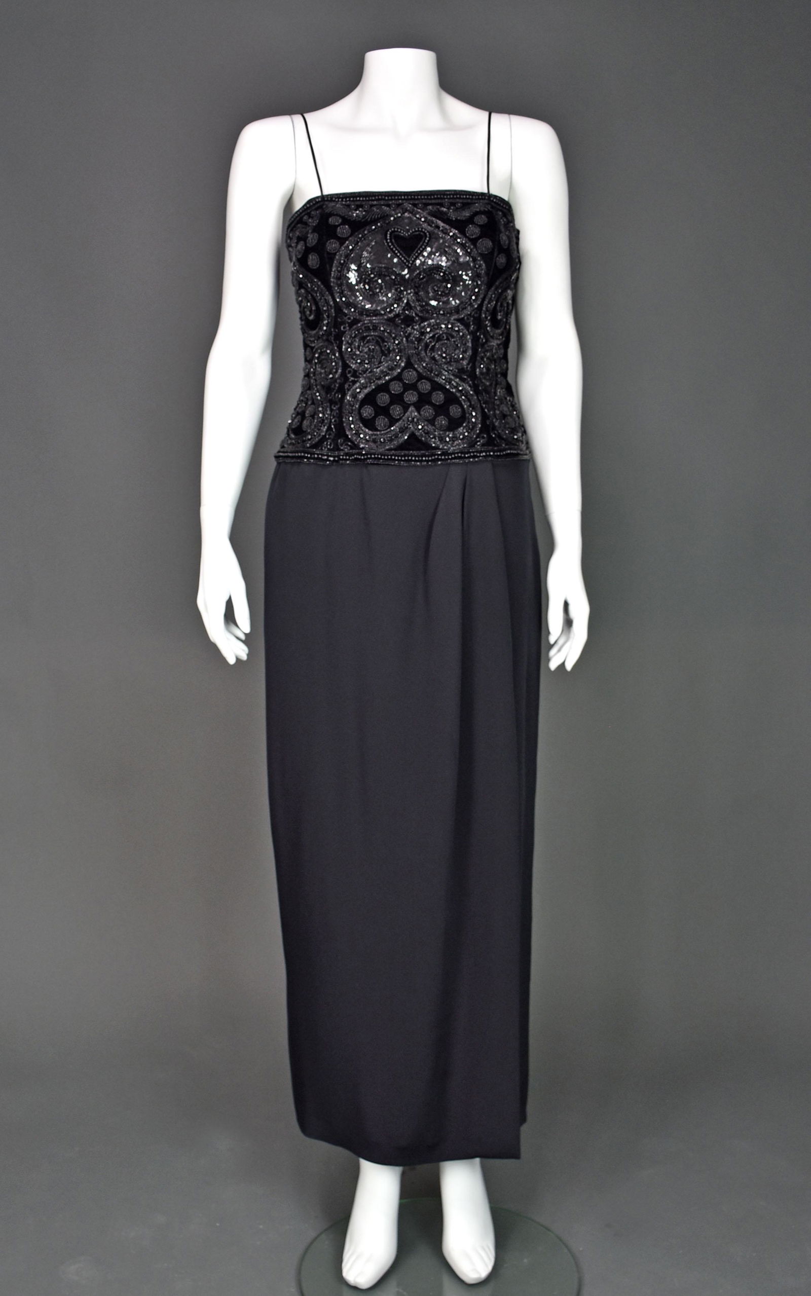 ESCADA COUTURE Vintage Black Silk Beaded Evening Dress: Long black evening dress From ESCADA COUTURE features a heavily beaded bodice and a dropped waist. A variety of jet beads and sequins form heart-shapes and other patterns on the black velvet bodice. B