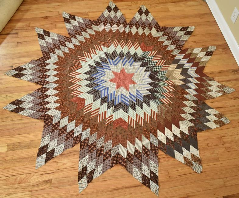RARE 1870's 14-Point Star Quilt Top: Cotton 1970's 14-point star quilt top, all hand pieced with elegant 19th century fabrics. It measures 70" from point to point, and is in excellent condition, with the occasional light age spot and no 