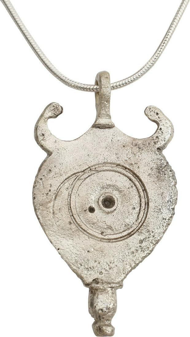 ROMAN LEGIONARY ARMOR MOUNT, 100-300 AD: For the military pteruges, the leather scale armor element worn around the waist. These served as additional protection as they would help absorb a sword or spear blow. Silvered bronze, 1 3/8" height.