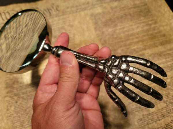 Skeleton Magnifying Glass Desk Hand Lens: 9 1/2" Long x 4" Wide Such a neat reproduction antique skeleton magnifying glass. The skeleton handle is all metal and aged to look old. The magnifying glass functions as it should. Makes a great acce