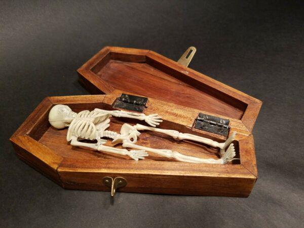 Miniature RIP Coffin w Skeleton: 7" Long x 3 1/4" Wide x 1 3/4" High Such a neat antique style item! The hardwood box/coffin has RIP engraved on the top of the lid. The latch and hinges on the coffin are brass aged to look old. On th