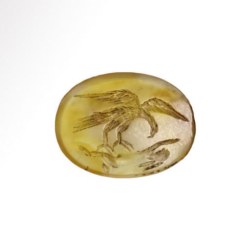 Roman Yellow Stone Intaglio with Eagle and Hare: Title: Roman Yellow Stone Intaglio with Eagle and Hare Date & Origin: Roman, c. 2nd Century A.D. Description: Oval seal of yellow cornelian, engraved with an eagle flying holding a hare (rabbit) with 