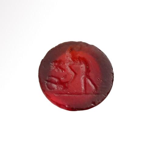 Roman Cornelian Intaglio with Cupid: Title: Roman Cornelian Intaglio with Cupid Date & Origin: Roman, 1st-2nd Century A.D. Description: Roman dark red cornelian intaglio showing winged Eros leaning forward to pick up an amphora or oil la