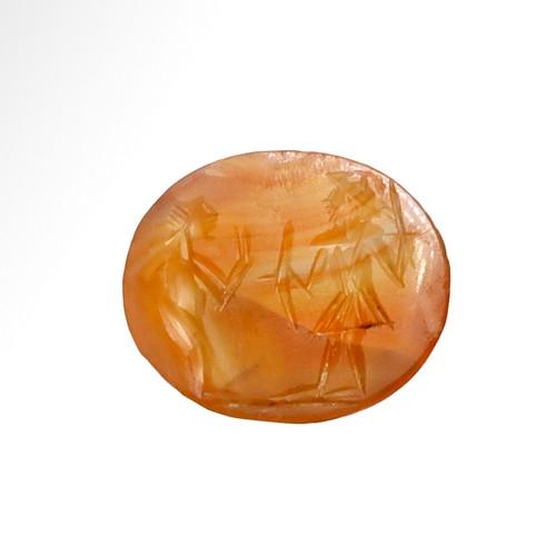 Roman Cornelian Intaglio with Soldier: Title: Roman Cornelian Intaglio with Soldier Date & Origin: Roman, 2nd-3rd Century A.D. Description: Round cornelian intaglio of red-orange colour, engraved with a soldier holding shield and sword fac