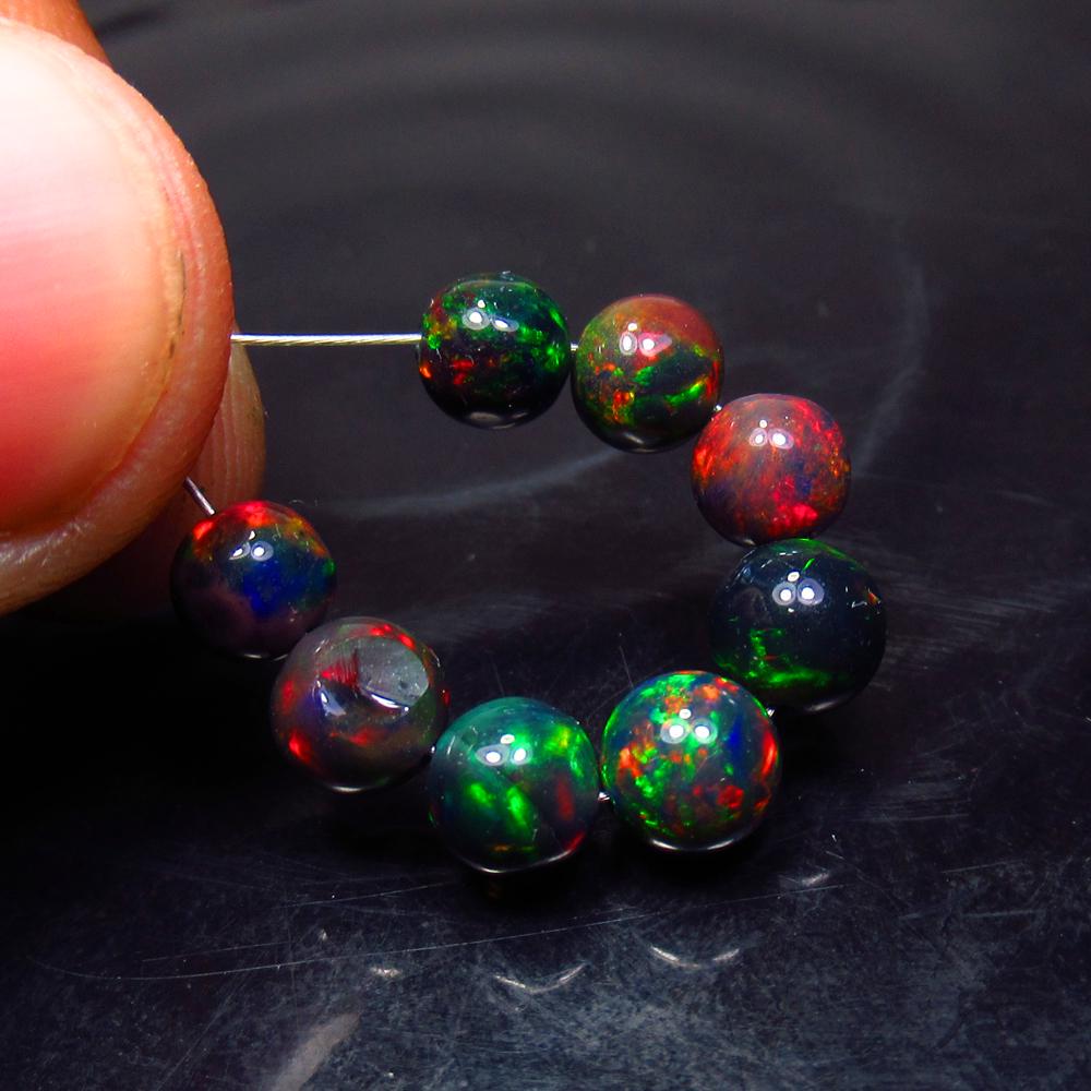 6.00 Ct Natural 8 Drilled Black Fire Opal Ball Beads: Title: 6.00 Ct Natural 8 Drilled Black Fire Opal Ball Beads Stone Clarity: Translucent Gemstones: Natural Black Opal Beads Carat Weights: 6 Size/Dimensions: 5.10 to 5.80 mm / 8 PC's Additional Informa
