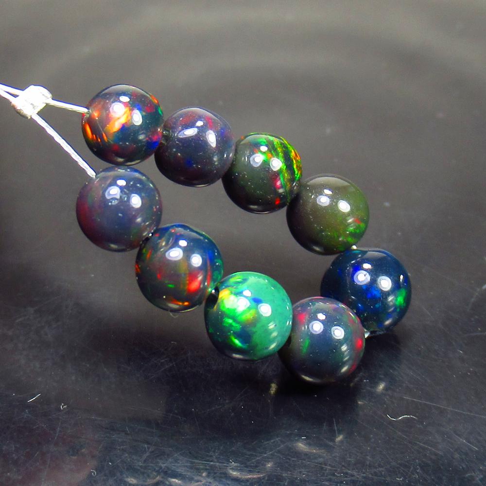 6.09 Ct Natural 9 Drilled Black Fire Opal Ball Beads: No Reserve! Title: 6.09 Ct Natural 9 Drilled Black Fire Opal Ball Beads Stone Clarity: Translucent Gemstones: Natural Black Opal Beads Carat Weights: 6.09 Size/Dimensions: 5.00 to 5.90 mm / 9 PC's Add