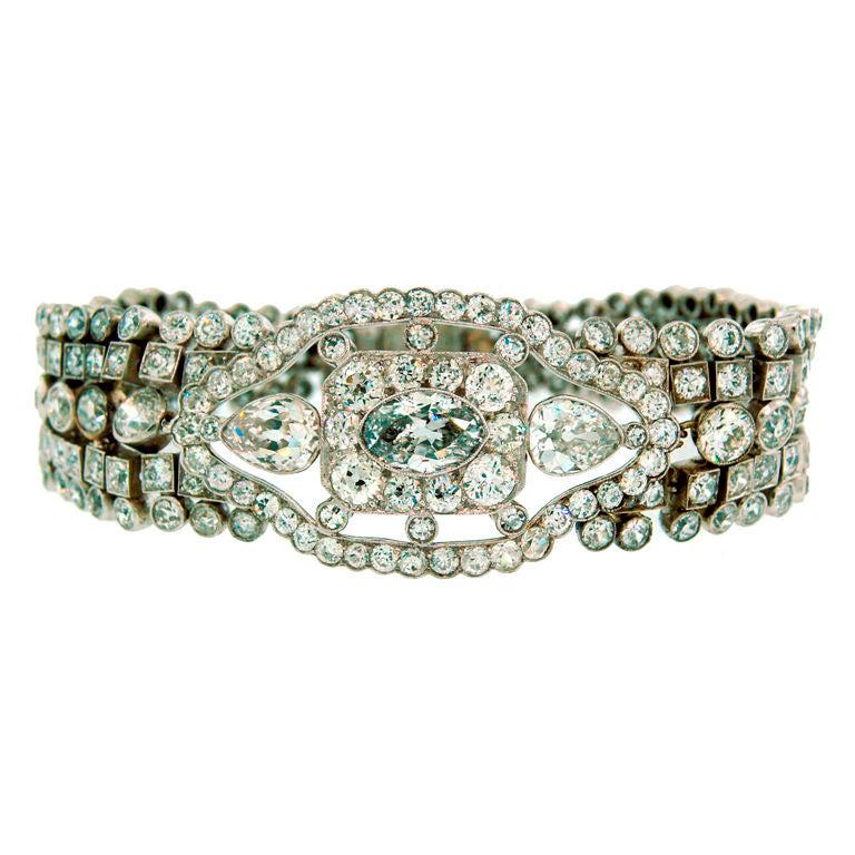 Art Deco Diamond Bracelet with Light Fancy Blue: Description: Timeless Art Deco diamond and platinum bracelet created in Europe in the 1930s. Its highlight is an approx. 1.32-ct marquise cut fancy grayish-blue diamond (I1 clarity) framed with cushio