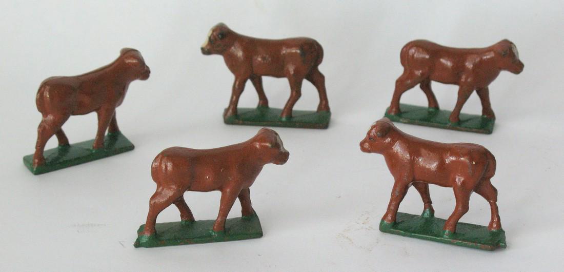 Group of vintage cast iron cow figures. (1 of 3)