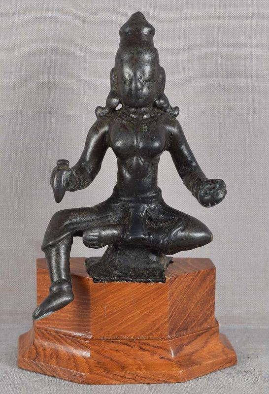 17/18c Indian bronze 2-armed GODDESS DURGA: 18th (may be as early as 17th) century votive Indian bronze sculpture depicting bare breasted goddess Durga sitting with one foot pending and holding a dagger and a bowl in her hands in her hands. Thi