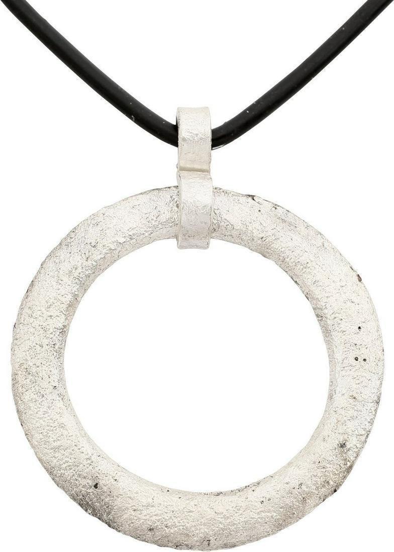 VIKING PROTECTIVE BROOCH NECKLACE 10th-11th C.: Bronze, well over 1 1/4" diameter. Low rounded faces on both sides forming ridged edges. Textured from burial. Worn in numbers, these were decorative as well as serving as a measure of protection from