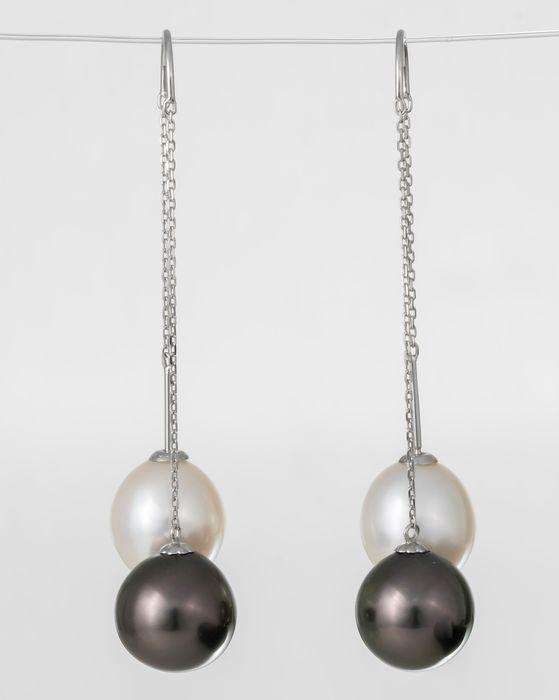 United Pearl - 10x11mm Peacock Tahitian Pearls - 18 kt.: Title: United Pearl - 10x11mm Peacock Tahitian Pearls - 18 kt. White gold - Earrings Description: A pair of elegant white gold earrings featuring a pair of peacock Tahitian pearls, noted for their mag
