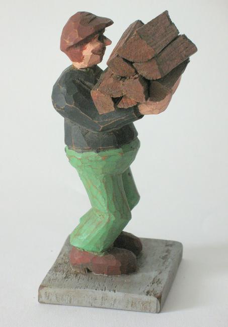 Vintage folk art carving of a man carrying wood. (1 of 2)