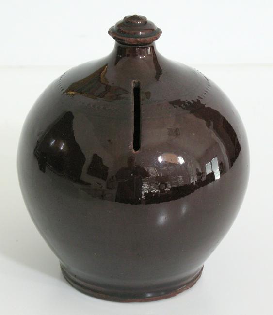 Antiques redware pottery penny bank.: Title: Antiques redware pottery penny bank. Date/Period: 1900's Dimension: 6" high Additional Information: Nice early Pennsylvania redware penny bank with a bold finale and having a great Albany slip