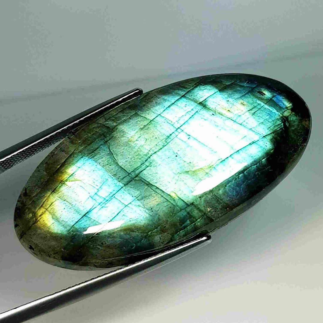 51.20 ct Natural Labradorite: No Reserve! Title: 51.20 ct Natural Labradorite Color/Clarity: Opaque Carat Weight: 51.2 Size/Dimensions: 42.10 x 21.30 x 6.80 Additional Information: Oval - USA Shipping: Domestic: Flat-rate of $7.0