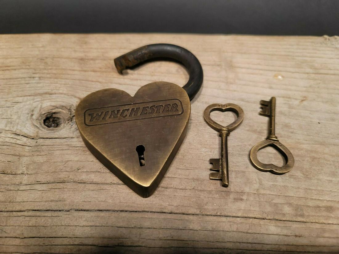 Brass Heart Winchester Firearms Ammo Box Padlock Lock: 3" tall x 4 1/4" Wide Nice reproduction brass winchester padlock! This lock is fully functional! Hard to tell its age. Heavy iron and brass. Great aged patina throughout. Limited quantity available! R