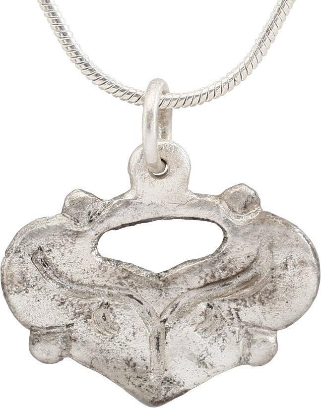 FINE VIKING HEART PENDANT, 10TH - 11TH CENTURY AD: Just under 3/4" width. Broad heart of natural (uncusped) form with quartered nubs and engraved trefoil below a pierced heart. A heart within a heart! Made by the open face mold technique. The heart st