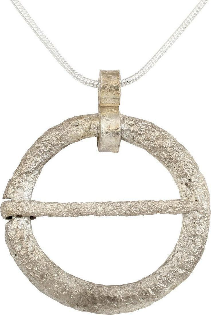 VIKING PROTECTIVE BROOCH NECKLACE 10TH C.AD: 10th century AD. Silvered bronze, over 1 1/8" diameter, relief decorated as a continuous floral swag or wreath. Notched for its cross pin which is intact. Surface textured from burial. Professionally 