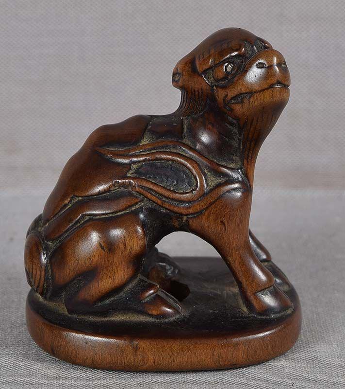 Early 19c netsuke mythical animal SUISEI ex Mang: Rare subject early 19th century netsuke of a mythical animal suisei - a creature with a single horn and a tortoise's carapace on the back, flames licking the sides of its body. It sits on an oval base