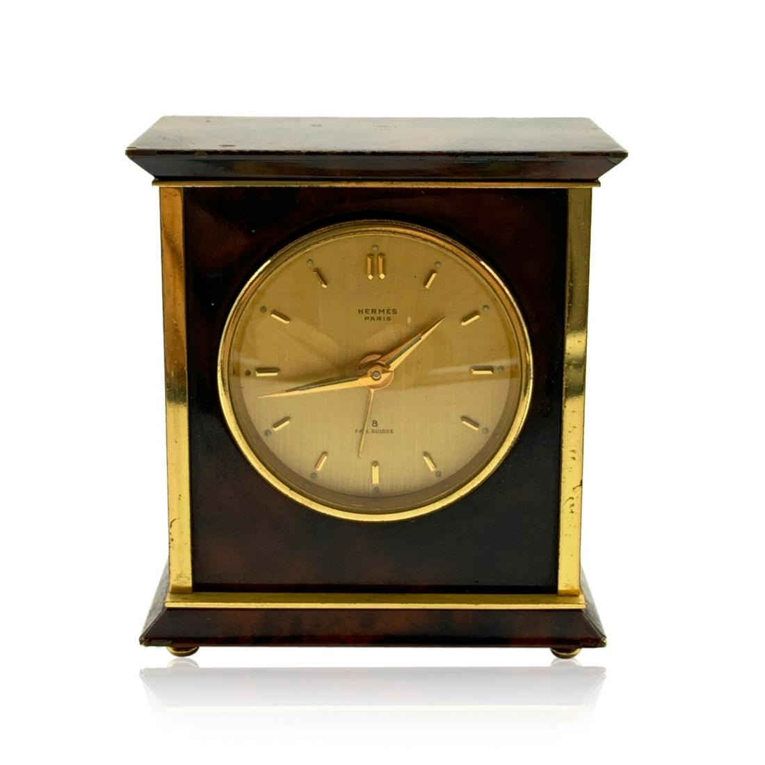 Hermes Paris Vintage Mechanical Table Travel Alarm: Hermes alarm travel clock mod. 1227 from the '70s. Made in brown marbled metal with gold plated metal detailing and markers. It is marked 'Hermes Paris' and 'Fab. Suisse' on the dial. Mechanical movem