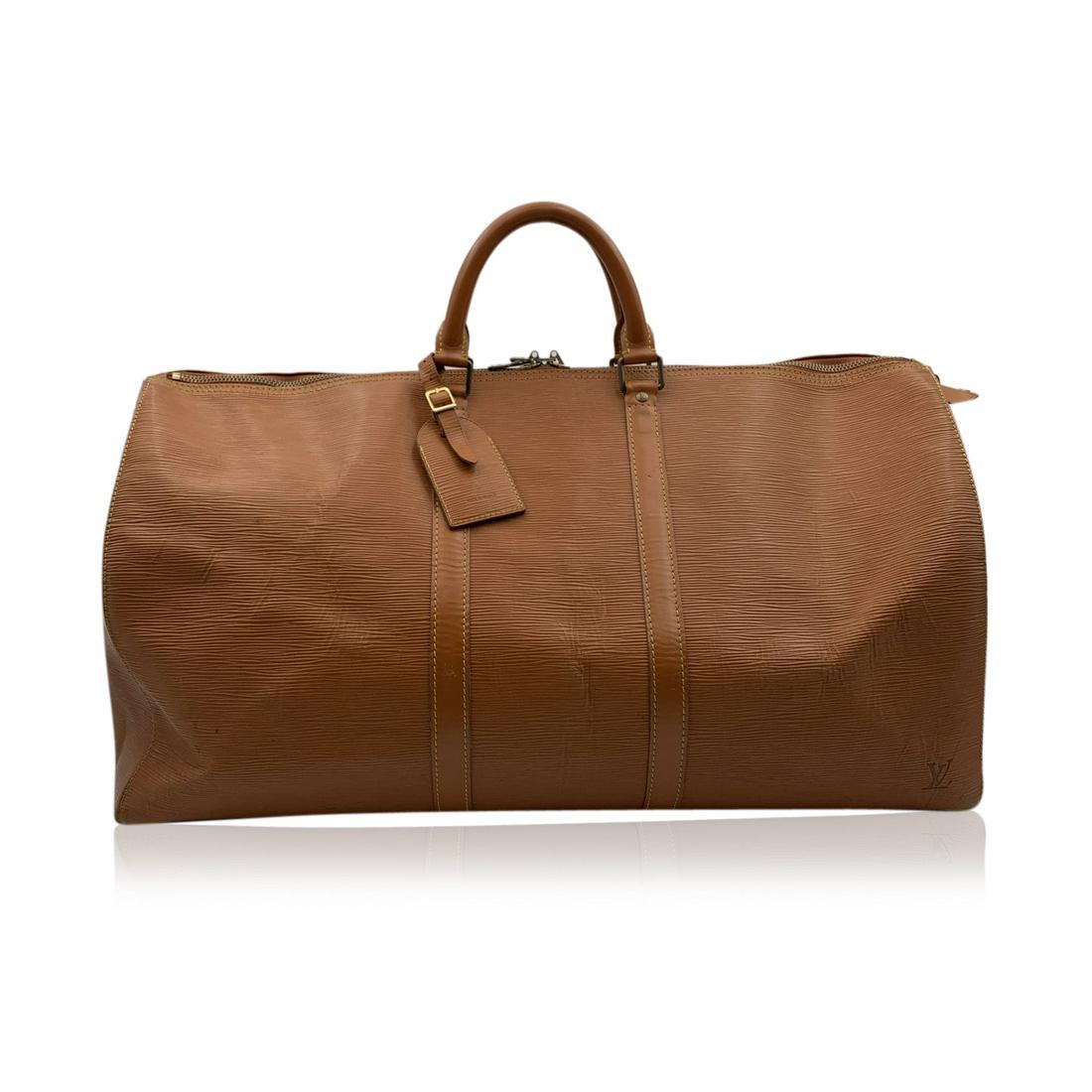 Louis Vuitton Tan Epi Leather Keepall 55 Travel Weekend: Louis Vuitton 'Keepall 55' Travel bag in durable tan Epi leather. Gold tone pieces. Double zip closure. Rounded leather handles. Side open pocket. Suede interior. Removable leather ID holder Details M