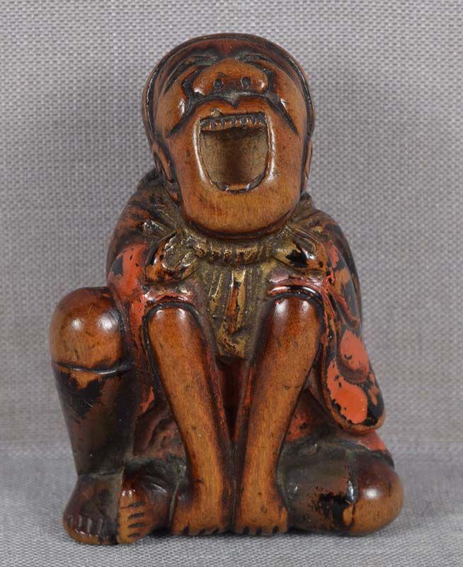 19c Negoro lacquer netsuke MONKEY TRAINER: Early 19th century lacquered wood netsuke of yawning and stretching sarumawashi - traveling monkey showman - with his pet climbing onto a cloth sack on his back. Unusual posture (both hands holding on
