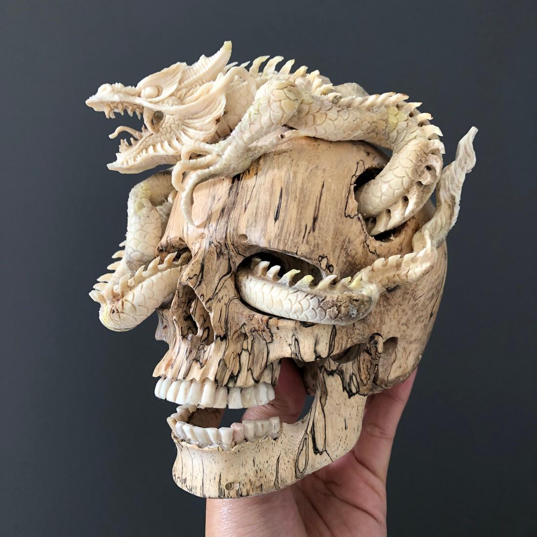 Human skull with a stunning carved dragon: Title: Human skull with a stunning carved dragon Dimension: H: 13 cm / 5.1 inches W: 12 cm / 4.7 inches L: 13 cm / 5.1 inches Description: A tamarind wooden human skull with stunning dragon carved out