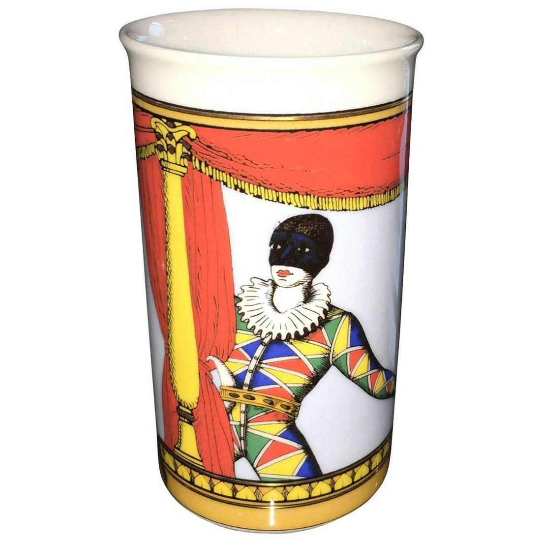 Fornasetti Orange, Blue, Yellow, Gold & Green Court: Title: Fornasetti Orange, Blue, Yellow, Gold & Green Court Jester White Porcelain Vase Description: Offered is a signed Mid-Century Modern brightly colored in orange, blue, yellow, green and black cou