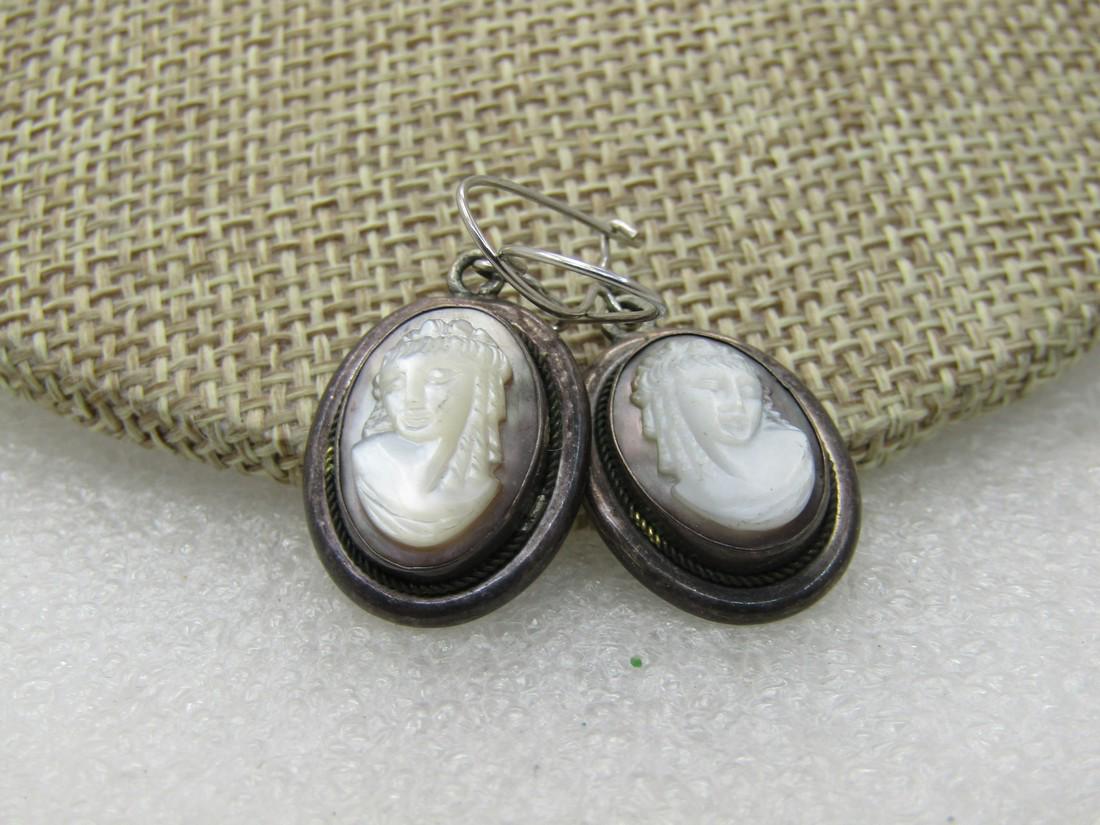 Vintage Sterling Silver Abalone Mother-of-Pearl Cameo: Vintage Sterling Silver Abalone Mother-of-Pearl Cameo Earrings, Pierced Dangle, 5.92 gr., 1.25" BY 5/8" ovales, bezel set with the cameo being appx. 14mm by 10mm. Good to very good condition. Not mark