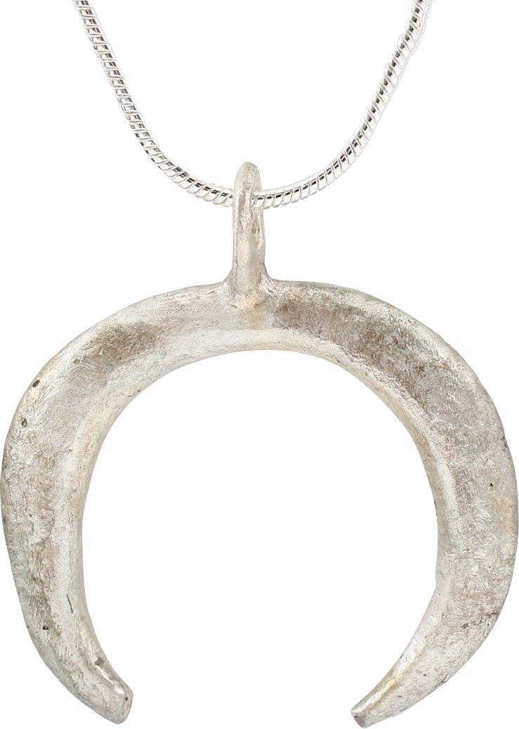 VIKING LUNAR PENDANT C.870-1050: Cambridgeshire, England. Over 1 1/8" width of opened circular form, tapered from the top to the terminals. Fundamental form to invoke supernatural guidance in navigating. Lightly textured from burial.