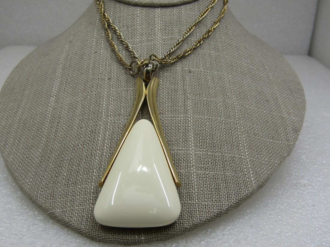 Vintage Crown Trifari Tan Modern Necklace, 24": Vintage Crown Trifari Tan Modern Necklace, 24" - Gold Tone. The chain is 2.5mm twisted link with spring clasp. The pendant has a tan lucite triangular accent in a moder inverted V frame. The pendant i
