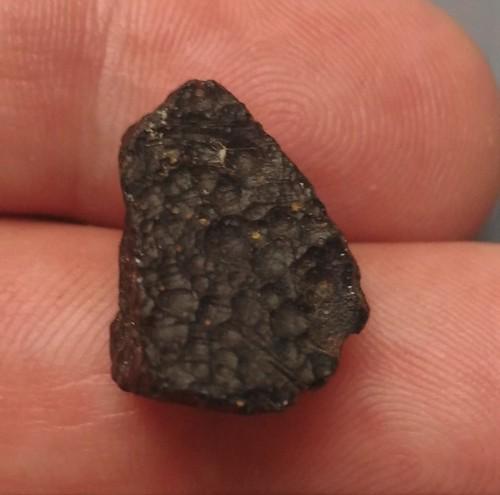 PHILIPPINITE TEKTITE - FROM METEORITE IMPACT: Title: PHILIPPINITE TEKTITE - FROM METEORITE IMPACT Origin: Paracale, Camarines Norte, Luzon, Philippines Size: 1.5x1x1 cm / 2 gram Description: small edged rizalite/philippinite tektite with pits all