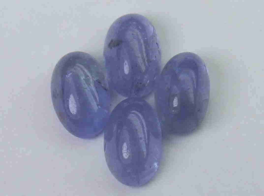 2.10 cts Natural Tanzanite Lot: No Reserve! Gemstone : Natural Tanzanite Shape and cut : Oval cabochan Weight : 2.10 Carats Measurements : 5.83x3.722.89 mm - 5.54x3.47x2.51 mm Number of Stone : 4 Color : voilite Transprancy : Transp
