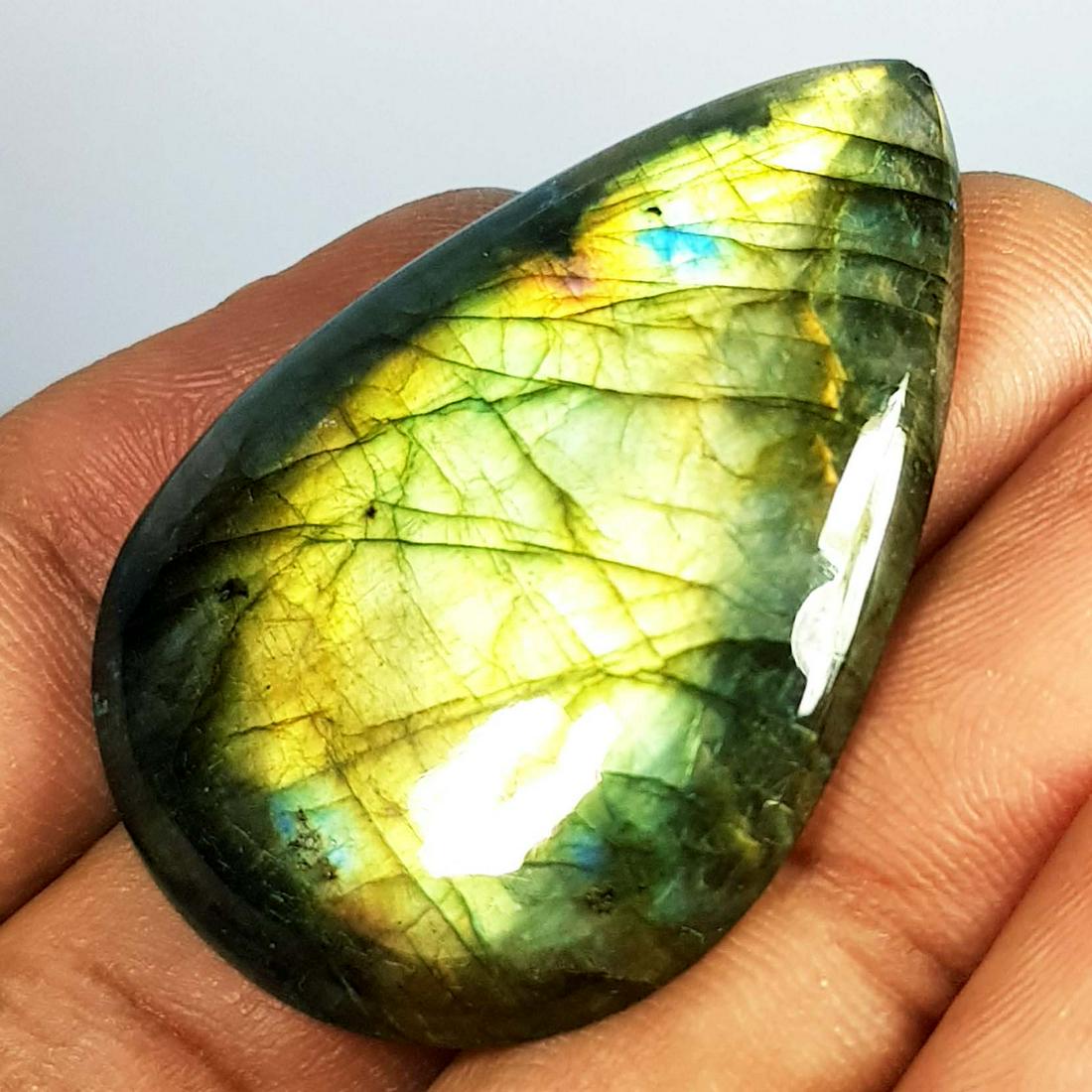 52.64 ct Natural Labradorite: No Reserve! Title: 52.64 ct Natural Labradorite Color/Clarity: Opaque Gemstones: Gemstones Carat Weights: 52.64 Size/Dimensions: 40.75 x 28.25 x 5.80 Additional Information: Pear - USA Shipping: Dome