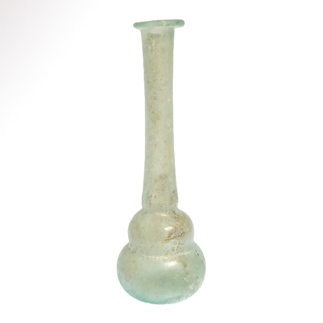 Roman Glass Unguentarium, c. 1st-2nd Century A.D.: Title: Roman Glass Unguentarium, c. 1st-2nd Century A.D. Date/Origin: Roman, c. 1st-2nd Century A.D. Description: Pear shape body and long cylindrical neck, everted and in-turned lip. Materials: Glass