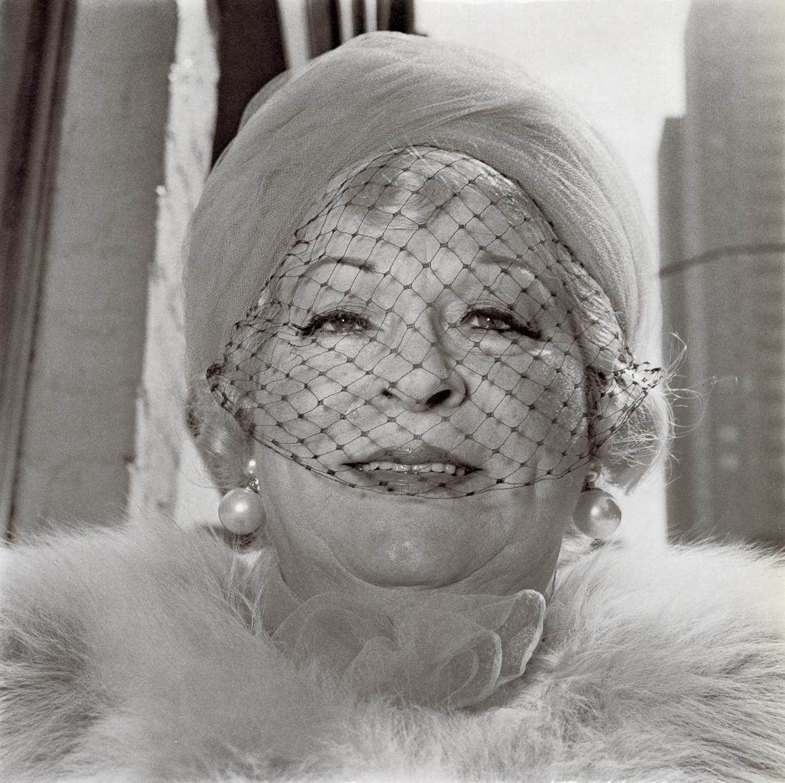 DIANE ARBUS - Woman with a Veil on Fifth Ave, 1968: Title: Woman with a Veil on Fifth Avenue, NYC, 1968 Medium: Photo Litho, 1972, USA Dimensions: 8.25x8.25" Description: Heat Wax Mounted on 11x14" Conservation Board Artist Bio: Diane Arbus was an Amer