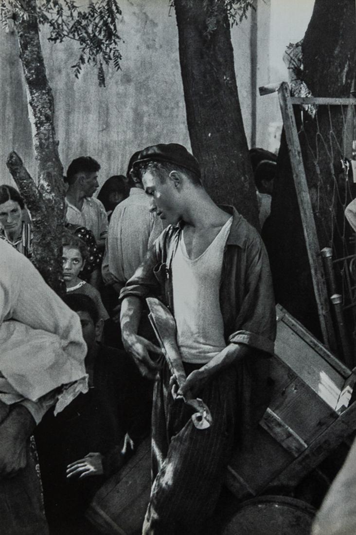 HENRI CARTIER-BRESSON - Market in Zugdidi: Title: Market in Zugdidi. Young man idly strumming Medium: Sheet Fed Gravure, 1955, France Dimensions: 9x13.6" Description: Heat Wax Mounted on 14x18" Conservation board Artist Bio: Henri Cartier-Bres