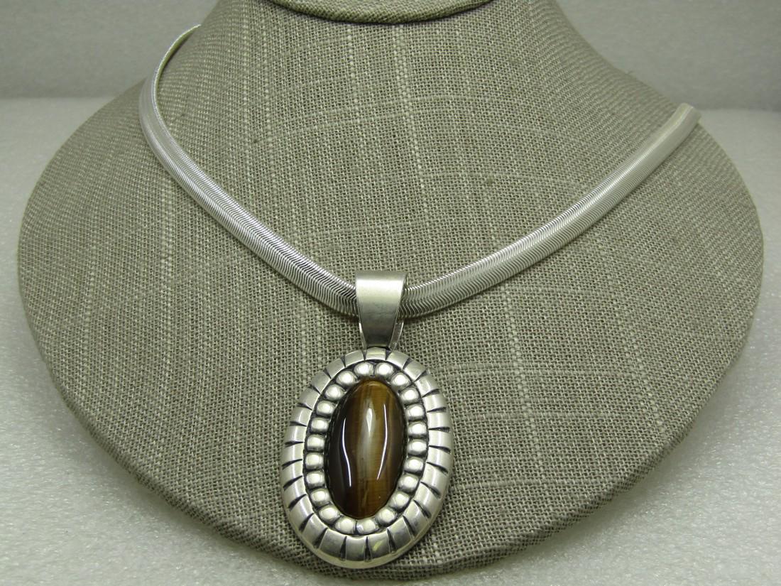 Sterling Southwestern Carolyn Pollack ReliosTiger's Eye: Sterling Southwestern Carolyn Pollack ReliosTiger's Eye Necklace, 18" snake chain that is 6mm wide. The pendant has a wide bail with opening of 10.5mm and is 2.5" long and 1.25" wide. The tiger's eye 