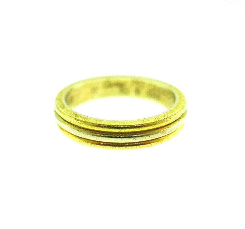 Cartier 18k White and Yellow Gold Band Ring: NS AOO Cartier 18k White and Yellow Gold Band Ring Stamped with the Cartier's maker's mark, a hallmark for 18k gold, a serial number and the year of making (1988) There is engraved writing inside the 
