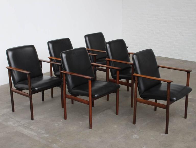 Set of Six Rosewood Conference Chairs by Arne Vodder: Set of 6 large conference or dining chairs designed by Arne Vodder for Sibast Furniture Denmark, 1960s. The chairs are made out of top quality solid Brazilian rosewood and upholstered with black leath
