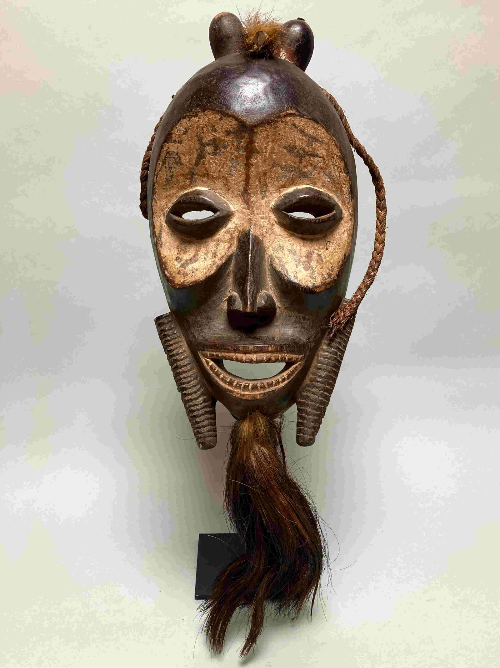 African Kagle mask from the Dan, Ivory Coast. These: African Kagle mask from the Dan, Ivory Coast. These masks are used in initiation rites. Hand carved from a single piece of wood, with pigments, plant fibers and animal tail. Signs of wear, drying crac